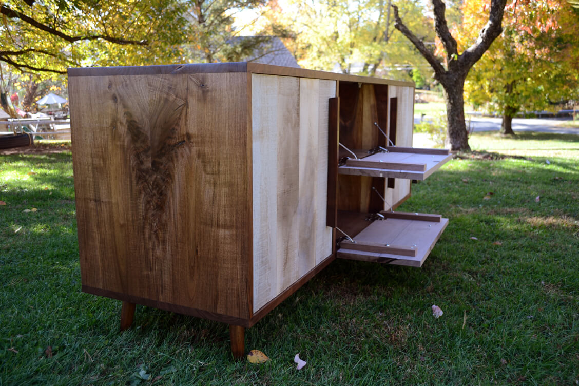 A custom walnut media cabinet with grain figure all solid wood. Rough sawn drop down doors www.brasstackshome.com
